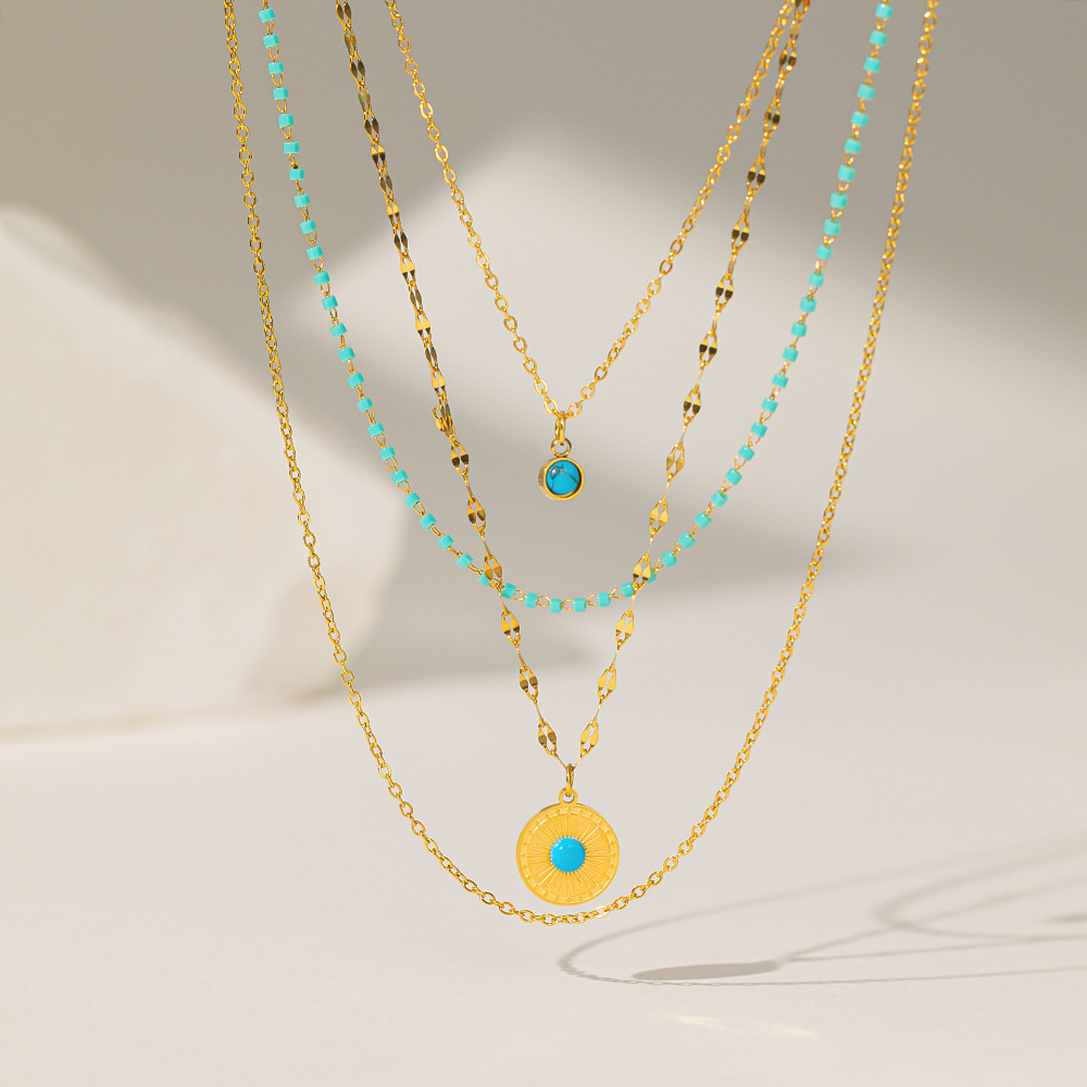 Collier pendentif rond en acier titane irrégulier avec turquoise